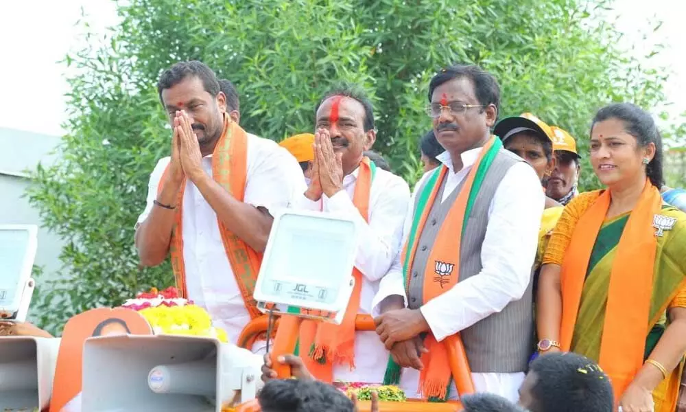 BJP candidate for Huzurabad by-election Eatala Rajender and MLA Raghunandan Rao greet the public at an election rally at Yelbaka in Veenavanka mandal on Monday