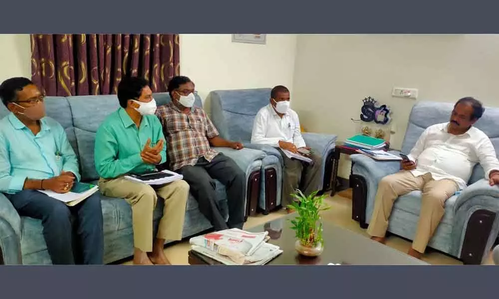 Agriculture Minister Kurasala Kannababu addressing a meeting with Agriculture department deputy director N Vijay Kumar and other officials in Kakinada on Tuesday