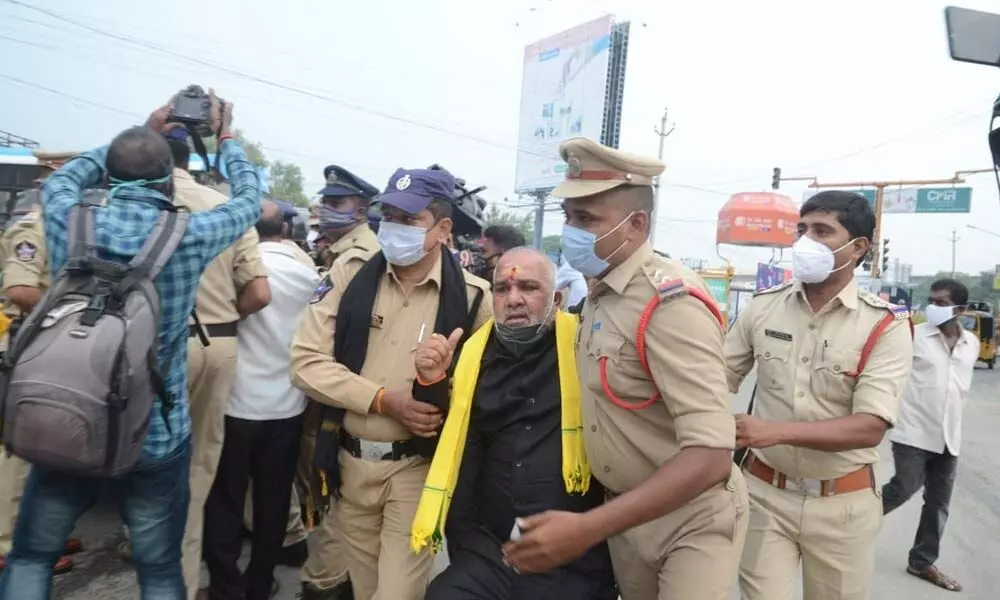 TDP corporator R C Muni Krishna being arrested by police at the Gandhi statue in Tirupati on Wednesday