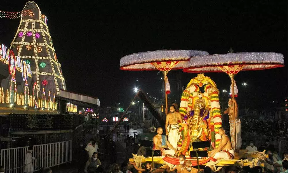 Lord Malayappa Swamy being taken out in a procession on Garuda Vahanam at Tirumala on Wednesday