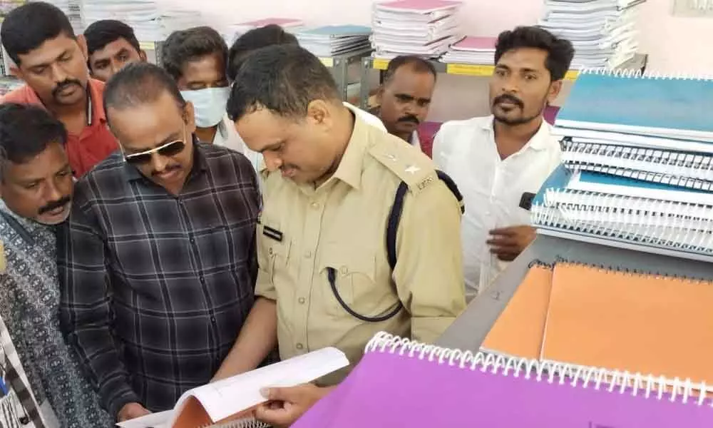 Superintendent of Police K Fakirappa Kaginelli having a look at the Civil services coaching material at the district police administrative building in Anantapur