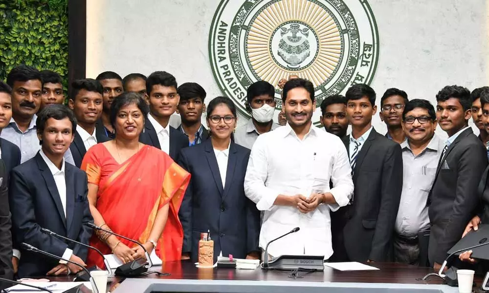 Chief Minister YS Jagan Mohan Reddy with IIT rankers from govt welfare schools and gurukuls, at his camp office in Tadepalli on Tuesday