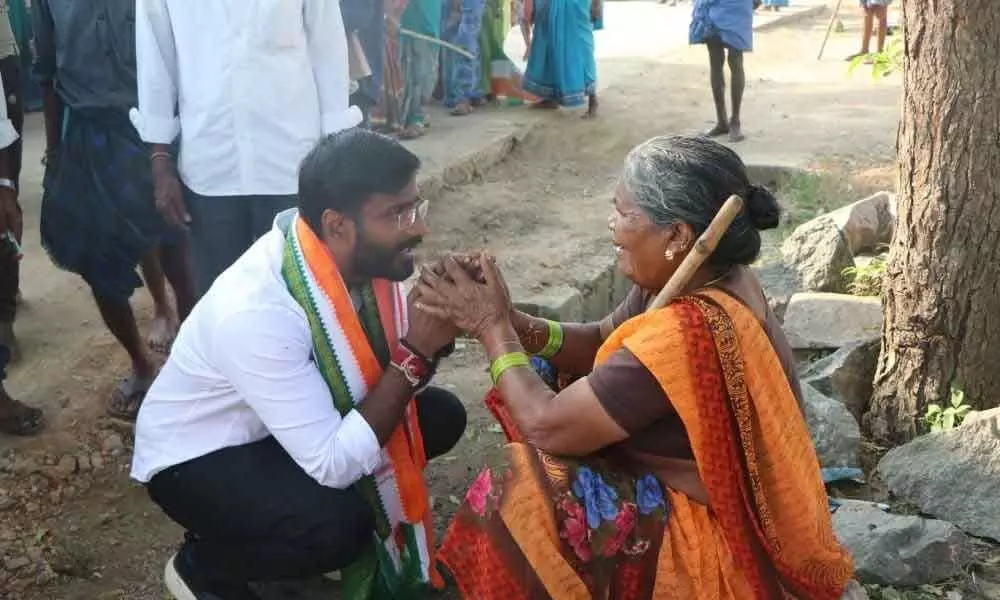 Congress candidate in the by-election to the Huzurabad assembly seat Balmoor Venkat asking an elderly woman to vote for him in Kamalapur mandal of Hanumakonda district on Tuesday