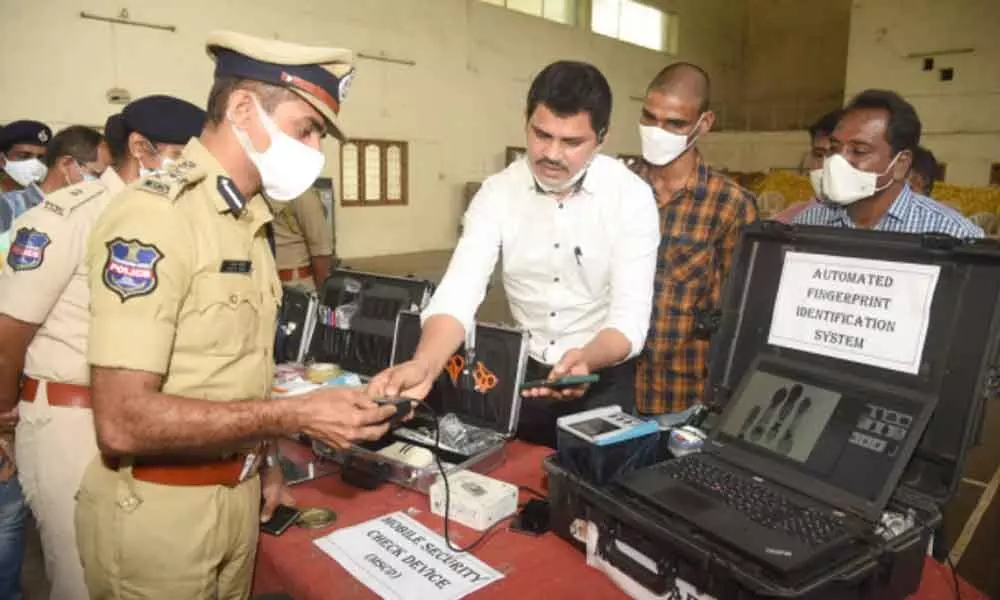 Commissioner of Police Tarun Joshi checking automated fingerprint identification system at the Open House at the Warangal Police Commissionerate on Tuesday