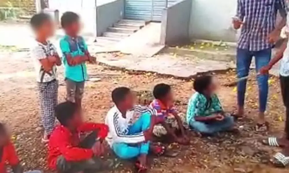 In a video clip, one of the accused can be seen beating primary school students with a stick.