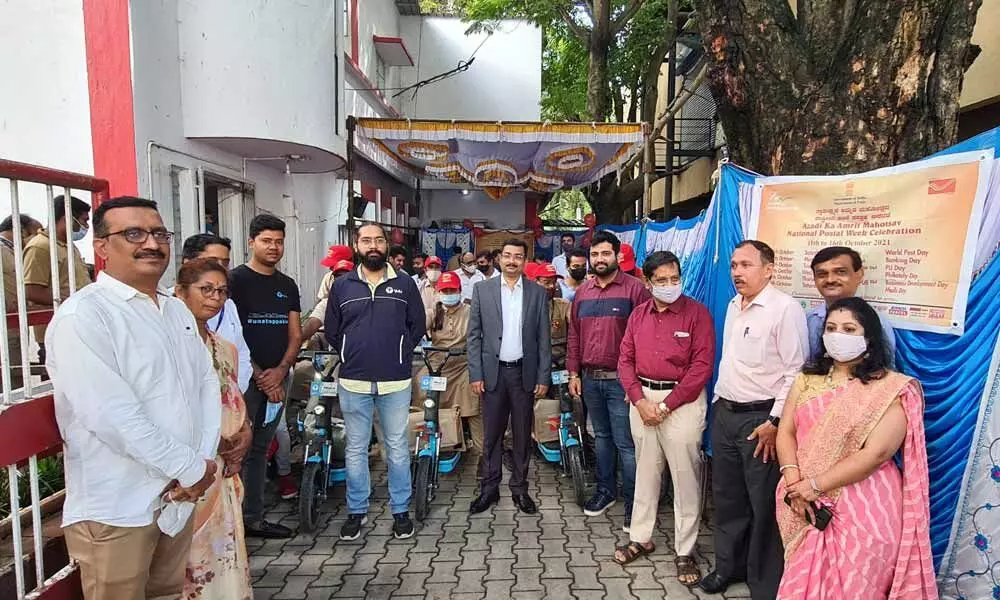 postmen deliver mail on e-bikes in Bengaluru