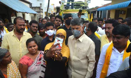 A woman takes a selife with TDP national president N Chandrababu Naidu during his second day tour in Kuppam on Saturday