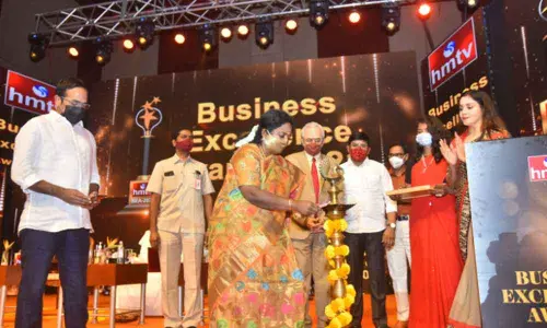 Governor Dr Tamilisai Soundararajan, BJP spokesperson Krishna Saagar Rao, National Stock Exchange Director K Narasimha Murthy lighting the lamp marking the inauguration of hmtv Business Excellence Awards programme at HICC in Hyderabad on Sunday	Photo: Adula Krishna