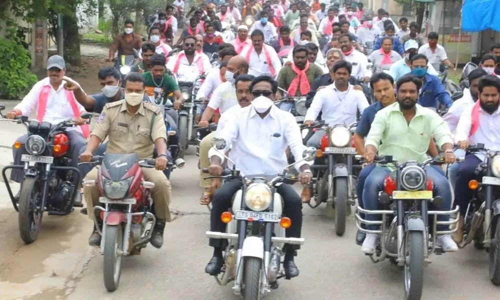 Puvvada Ajay takes a bike ride to distribute Kalyana Lakshmi cheques