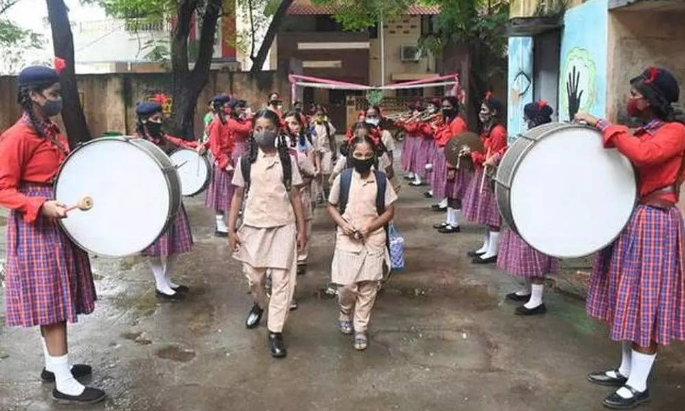 With schools for classes I to VIII reopening today, after COVID-19 relexation, students being welcomed with flowers and playing music at a Greater Chennai Corporation girls Higher Secondary, Perambur, in Chennai.