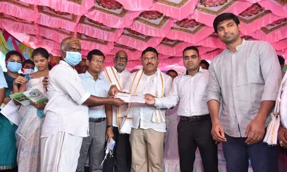 District Collector Vivek Yadav disturbing pattas to people cultivating forest lands at Anupalem on Wednesday