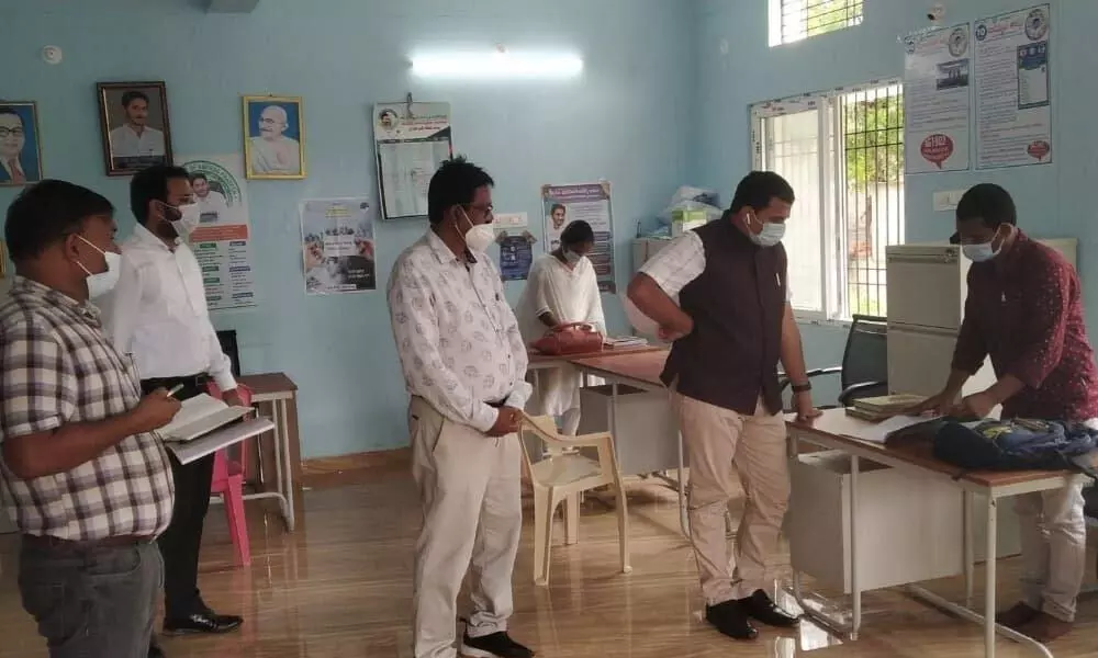 District Collector V Vijaya Rama Raju conducting a surprise inspection at Tallapaka village secretariat in Rajampet mandal on Wednesday.