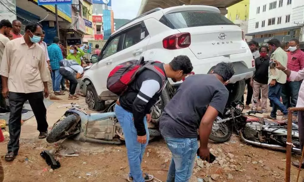 A car comes to a halt after crushing 9 two-wheelers and injuring 3 persons at Leela Mahal Junction in Tirupati on Friday