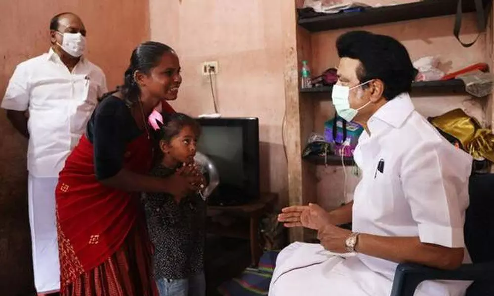 Tamil Nadu Chief Minister M.K. Stalin interacts with Narikurava woman Ashwini as he visits her home at Poonjeri village in Chengelpet distric on November 4, 2021. Photo: Twitter/@mkstalin