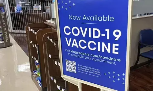 A sign notifies customers that COVID-19 vaccinations are available at a pharmacy in a grocery store in Monument, Colo. (Photo | AP)