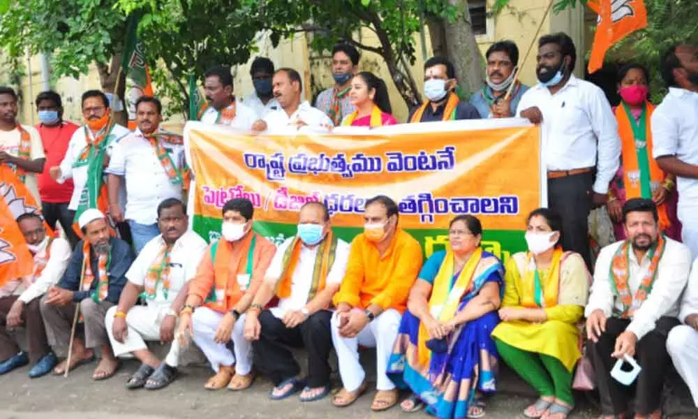 BJP national executive member Kanna Lakshminarayana, Central Labour Welfare Board chairman Valluru Jayaprakash Narayana, party district president Patibandla Rama Krishna and other leaders stage a protest demanding cut in state governemnt taxes on fuels at the collectorate in Guntur on Saturday