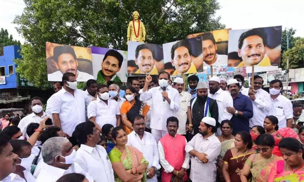 MLA Bhumana Karunakar Reddy addressing party activists to mark the completion of four years of Jagan Mohan Reddys Prajasankalpa Padayatra at YSR statue near TUDA Circle in Tirupati on Saturday
