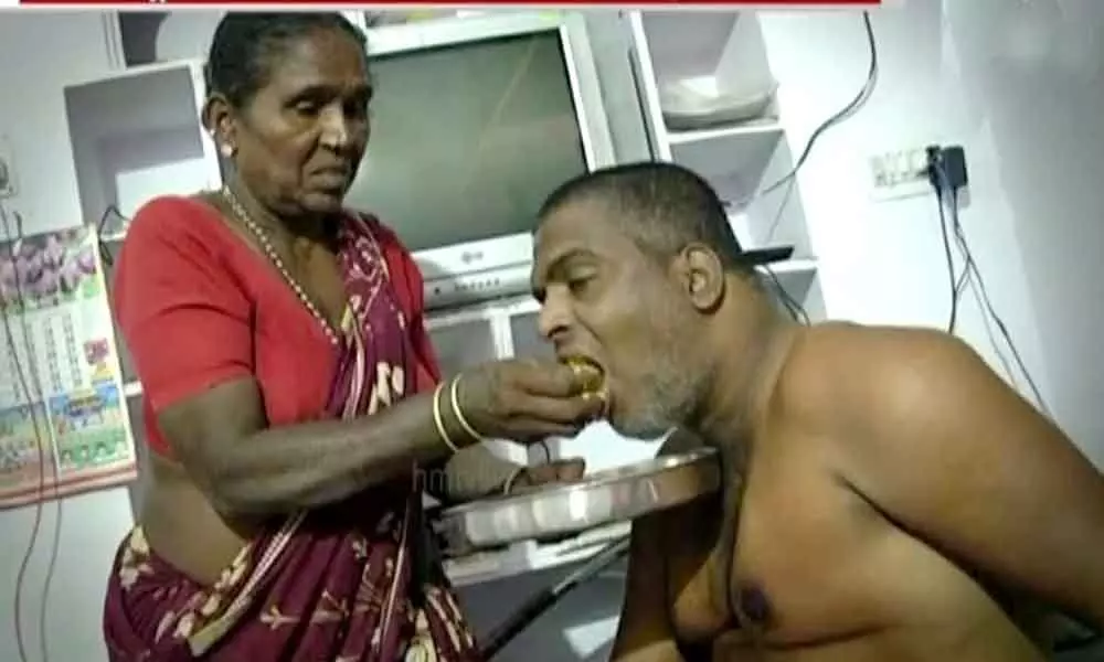 Anjamma feeding her son Gopal in Nalgonda on Saturday