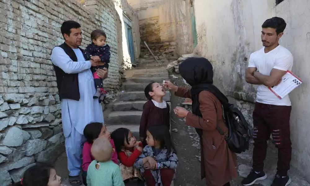 FILE PIC - Shabana Maani, gives a polio vaccination to a child in the old part of Kabul, Afghanistan, March 29, 2021.