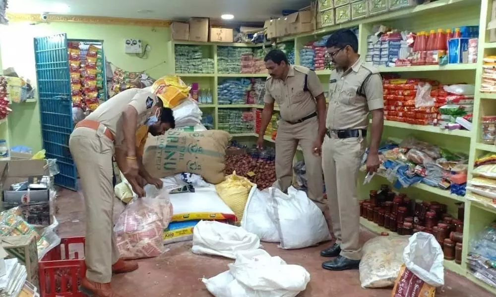 Police and SEB personnel conducting searches at a grocery shop as part of Operation Parivartana on Monday