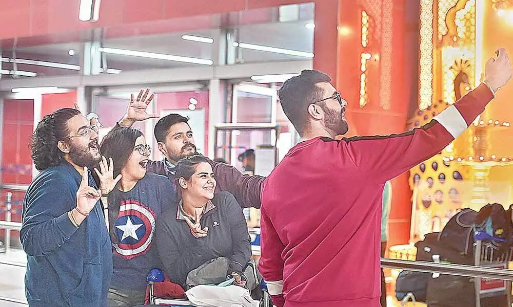 A passenger with her family and friends at the Terminal 3 of the IGI Airport, New Delhi on Monday. Flights to the US are set to resume services for the fully vaccinated passengers from Monday