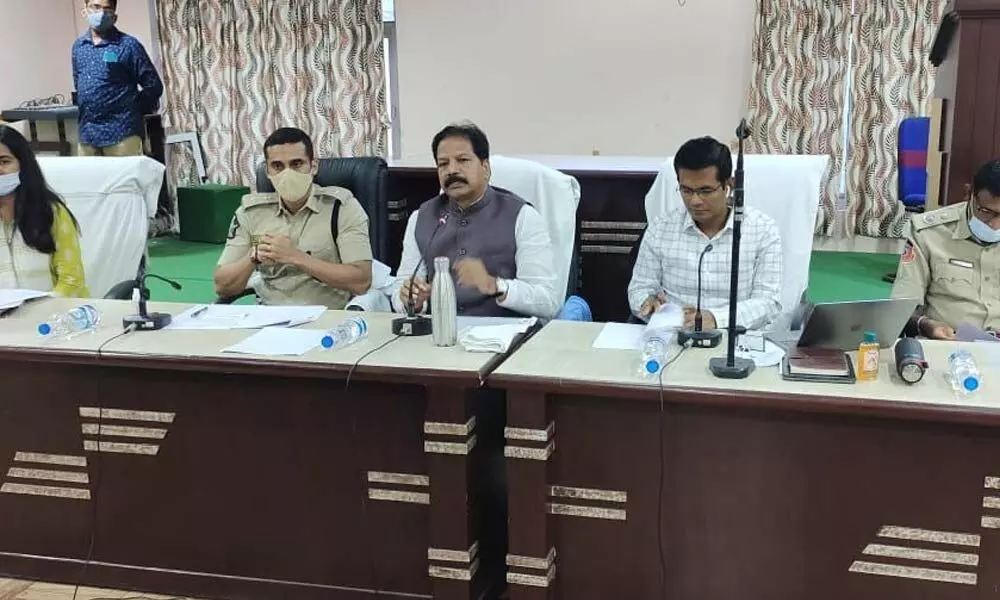 Deputy Speaker Kona Raghupati addressing a review meeting in Bapatla on Monday. Joint Collector AS Dinesh Kumar, Guntur Rural SP Vishal Gunni also seen