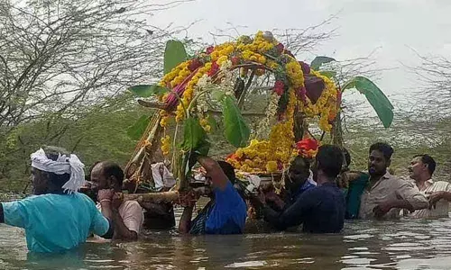 Villagers carry a body across the lake at Eluvichampatti in Pudukkottai district
