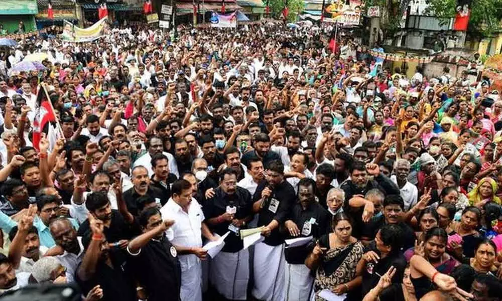 AIADMK members stage a demonstration against the DMK govt ver preremature release of water from the Mullaperiyar reservoir, in Madurai