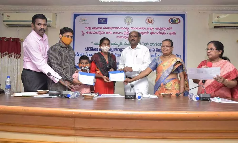 DSLA secretary K Ratnakumar distributing financial assistance to orphan children at a programme held in Guntur on Wednesday