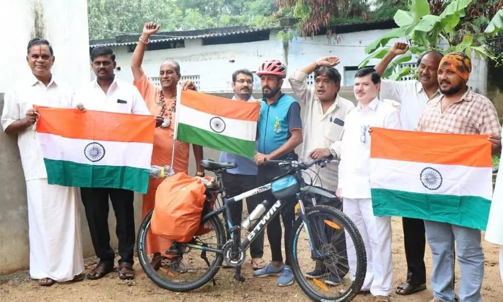Narpat Singh Rajpurohit, who is on a mission to protect environment and water on his bicycle, along with RSS and BJP leaders at Saraswathi Sisu Mandir school in Tirupati.  	Photo: Kalakata Radhakrishna