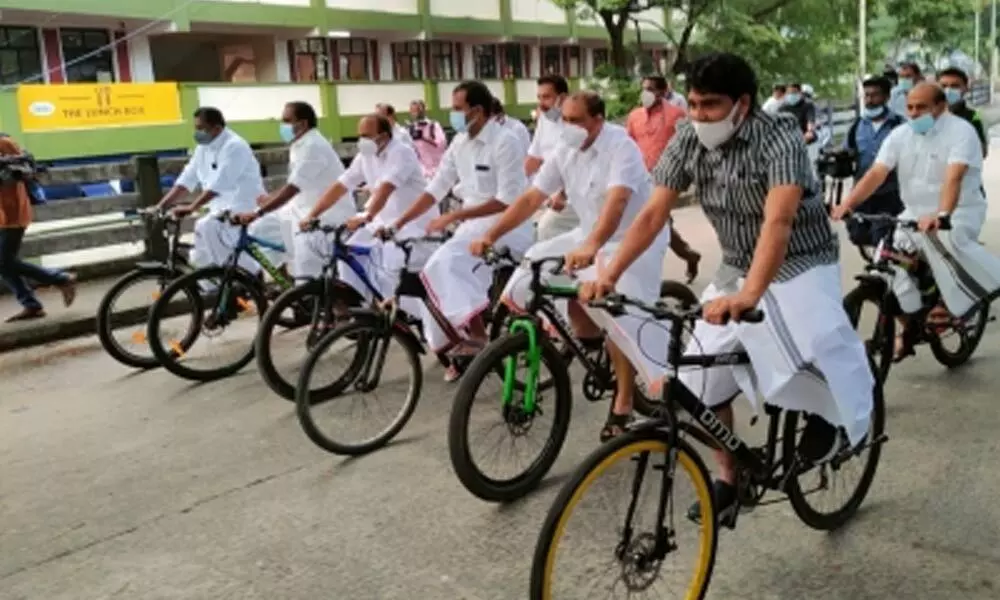 Kerala Opposition MLAs ride bicycles to Assembly in protest