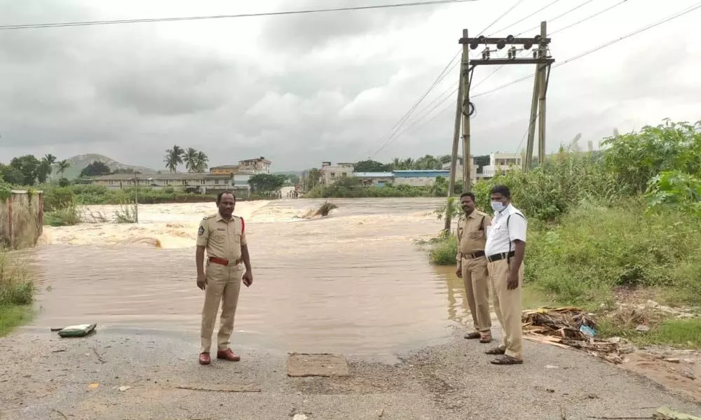 Police posted at places where floodwater is  flowing above the danger mark in Chittoor