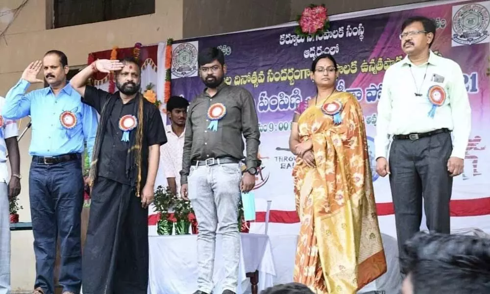 Mayor B Y Ramaiah, Commissioner DK Balaji and other officials receiving salute from the students during the inaugural ceremony of sport and games meet at outdoor stadium in Kurnool on Friday.