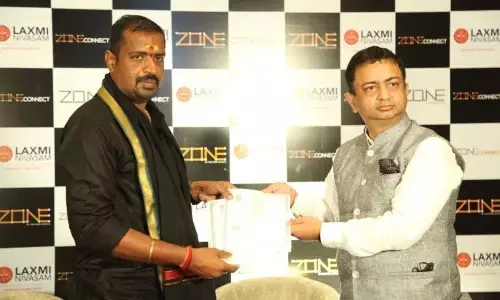 Laxmi Nivasam Developers CMD Rajendra Prasad and Zone by The Park National Head Vikas Ahluwalia exchanging term sheet papers in Hyderabad on Friday