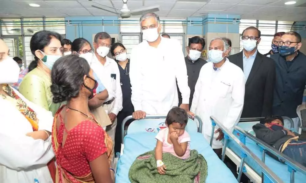 Health Minister Harish Rao interacting with a woman after inaugurating upgraded 100-bed ICU ward at Niloufer in Hyderabad on Saturday