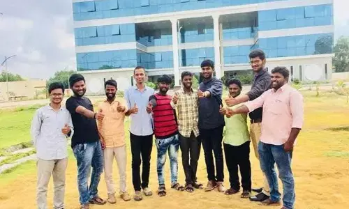 Students standing in front of Central University building