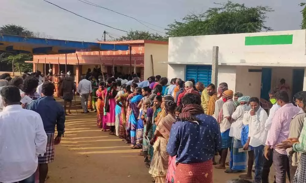 Voters wait in a queue to cast their votes in Kuppam municipal election on Monday