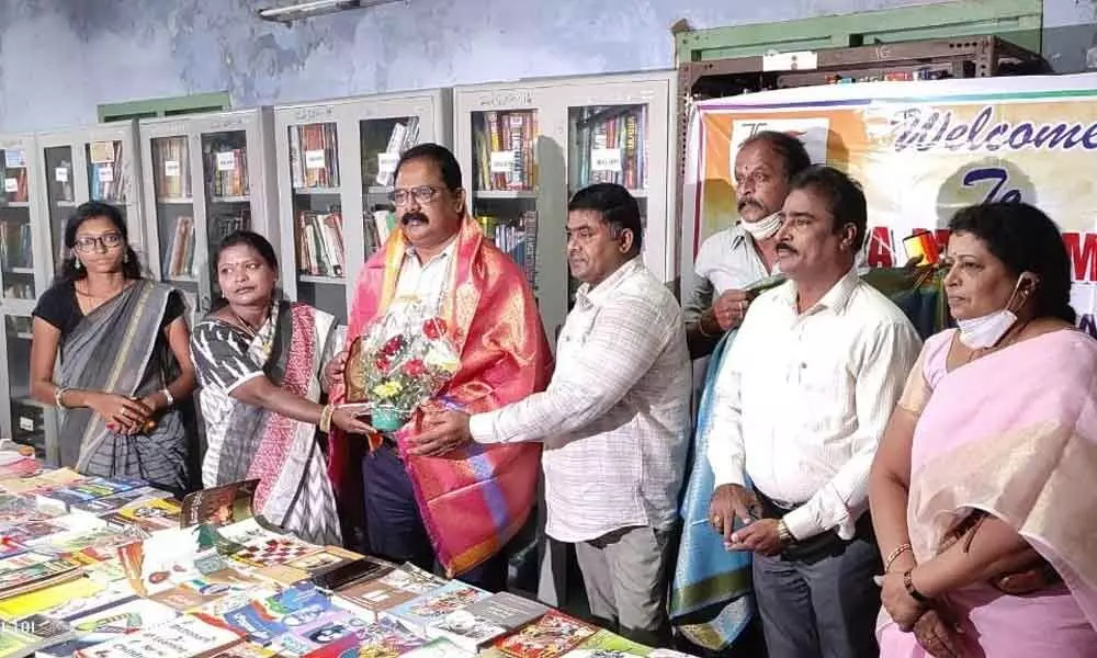 Zilla Grandhalaya Samstha secretary K Prakash and DEO Purushottam participating in the books exhibition at the District Library in Chittoor on Monday