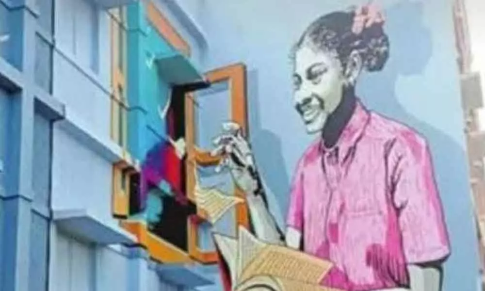 The huge wall painting admeasuring 26 feet tall and 50 feet wide of a girl student on the walls of the integrated hostel building on the club road connecting Badepally town in Jadcherla municipality