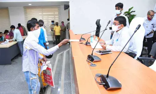 Additional Collector in-charge Venkatamadhav receiving complaints from a person during the ‘Prajavani session’ in Kamareddy on Monday