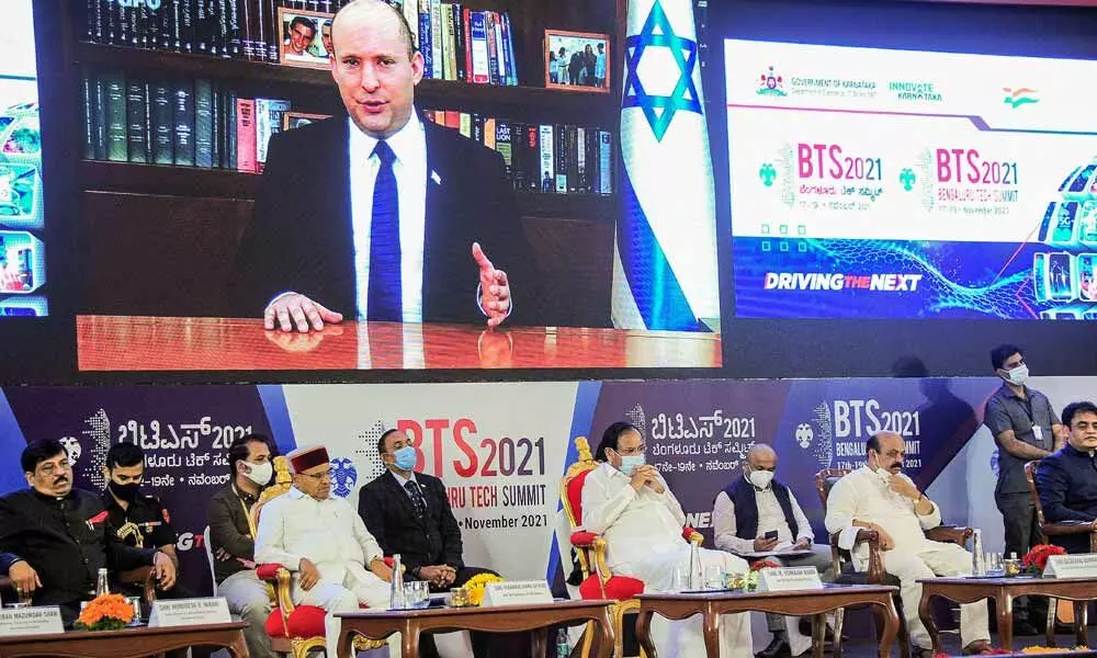 Israel Prime Minister Naftali Bennett addresses through a video link as Vice President M Venkaiah Naidu and others look on during the inauguration of the Bengaluru Tech Summit 2021 in Bengaluru, Wednesday