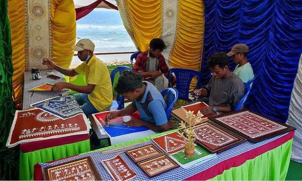 The Savara tribes engage in painting at the fair in Visakhapatnam