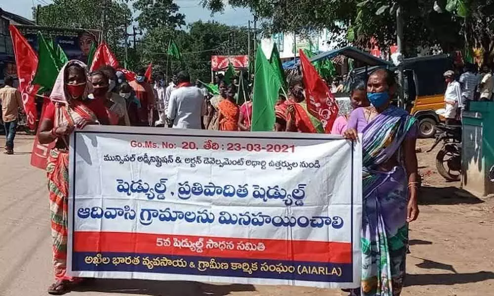 Adivasis taking out a rally at V Madugula in Visakhapatnam on Wednesday