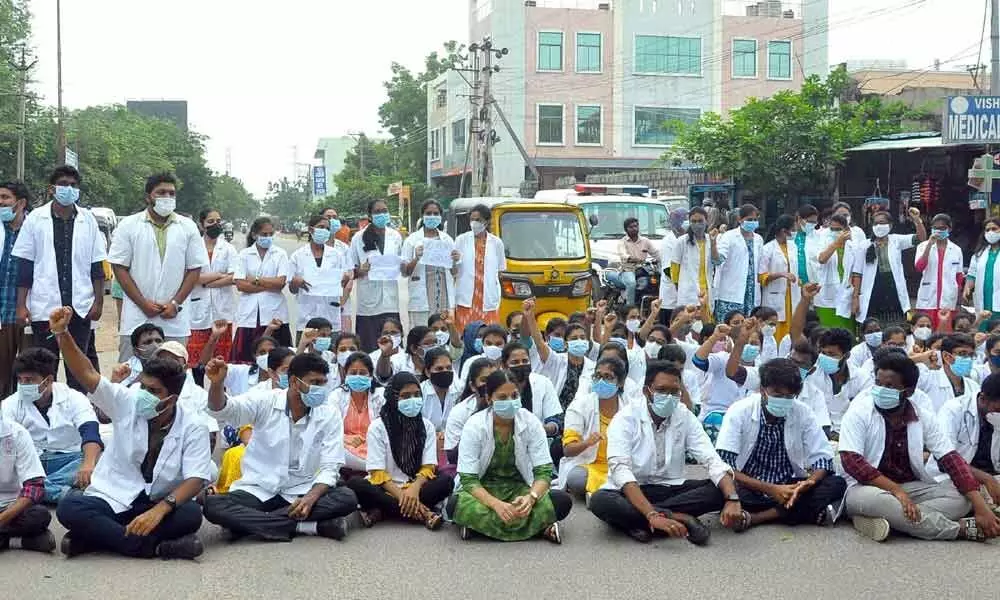 Medical College student staging dharna on the road near the entrance of District Govt Hospital in Nalgonda on Thursday