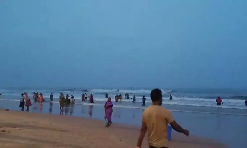 Devotees take holy bath at Suryalanka Beach