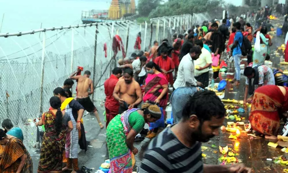 Devotees taking holy bath in Krishna River at Durgaghat in Vijayawada on Friday 			 	Photo: Ch Venkata Mastan