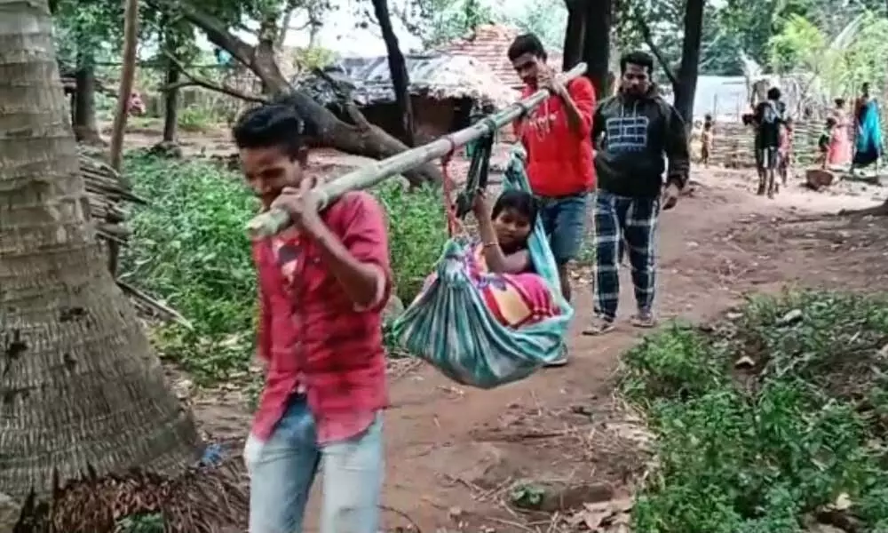 Pregnant woman Rajeswari being carried in a ‘doli’ for over 3 km to access an ambulance in Visakhapatnam on Friday