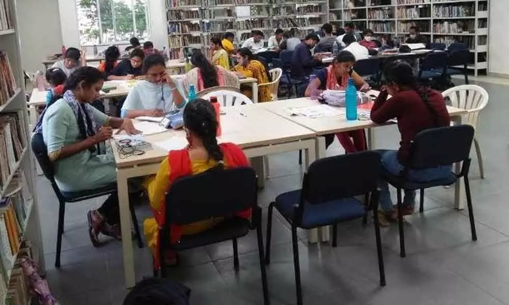 Readers engrossed in reading at Visakhapatnam Public Library in Dwarakanagar in Visakhapatnam