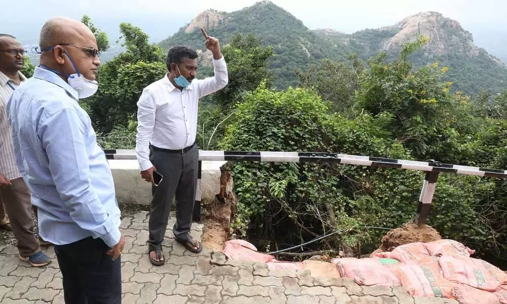 TTD EO K S Jawahar Reddy along with officials inspects a section of railing of ghat road (up) that was damaged due to rain and landslides, on Friday