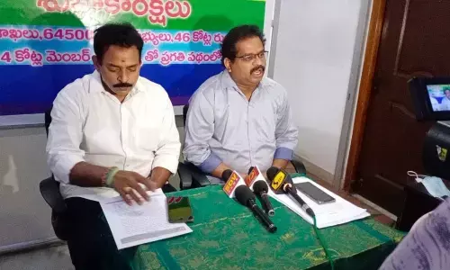 Chief executive officer of Andhra Pradesh Brahmin Cooperative Credit Society G Nagasai (right) addressing the media along with 33rd division corporator VNDSS Murthy in Vijayawada on Friday